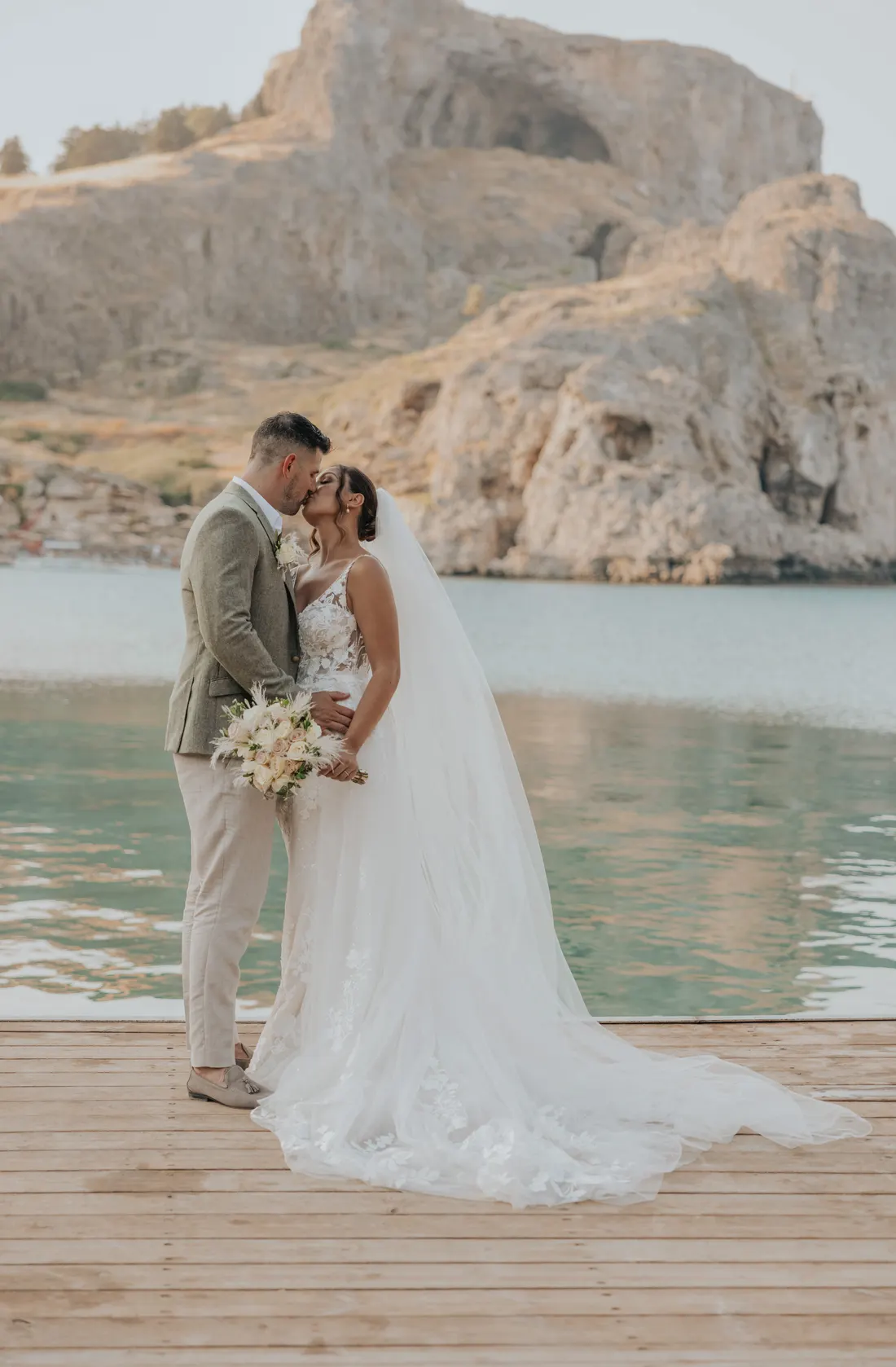 A couple kissing on a jetty in St Paul's Bay, Lindos